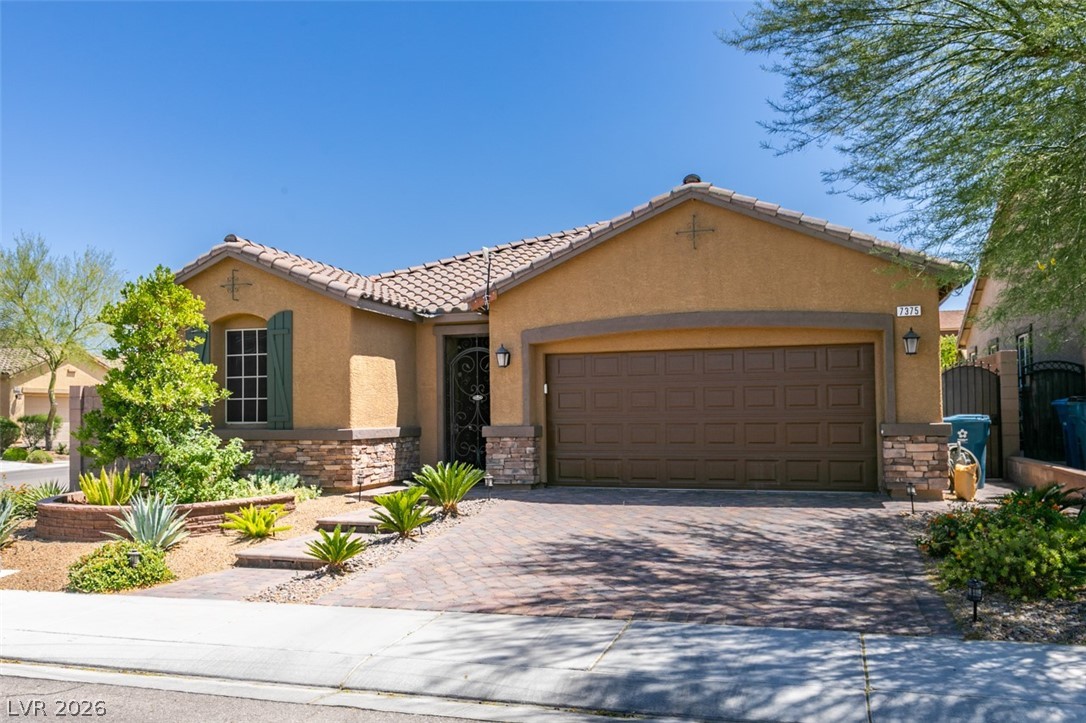 7375 Campbell Ranch Avenue Las Vegas, NV 89179 - Photo 1 of 45 A well-maintained desert landscape frames this welcoming single-story home with a paver driveway and walkway through a wrought iron gate.