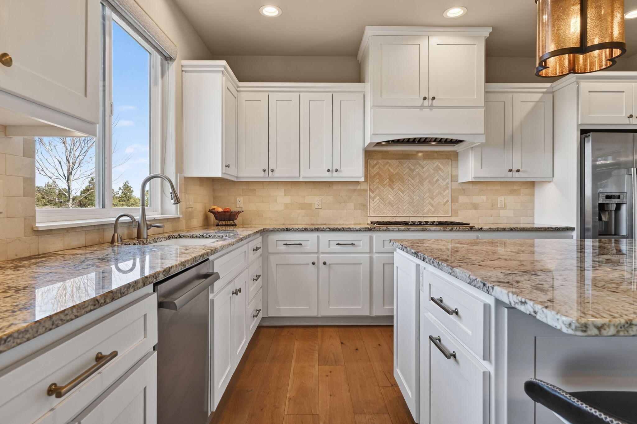 66355 Barr Road Bend, OR 97703 - Photo 14 of 56 a kitchen with granite countertop a sink stove and cabinets