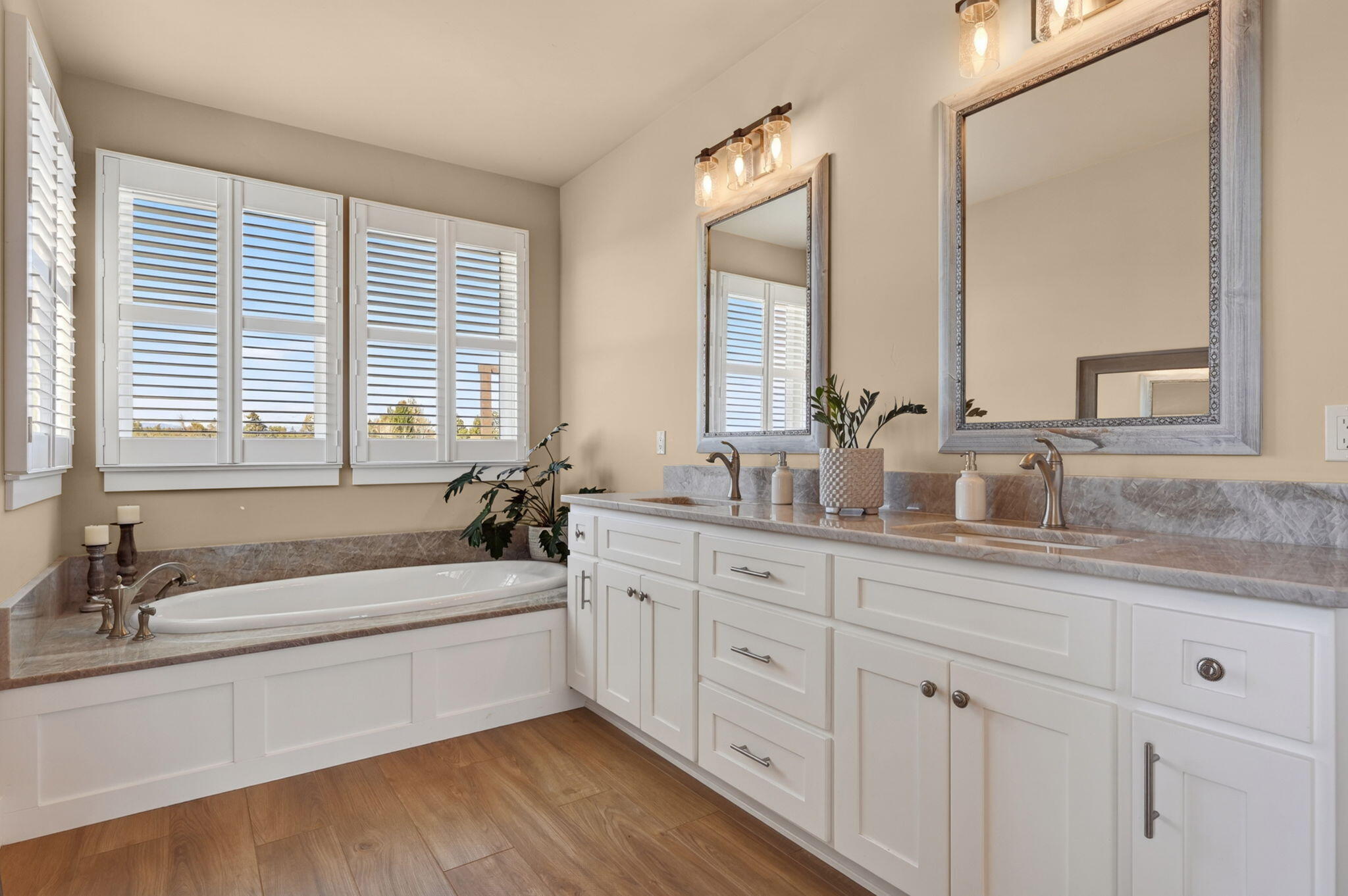 66355 Barr Road Bend, OR 97703 - Photo 22 of 56 a bathroom with double vanity sinks a large mirror and a bathtub