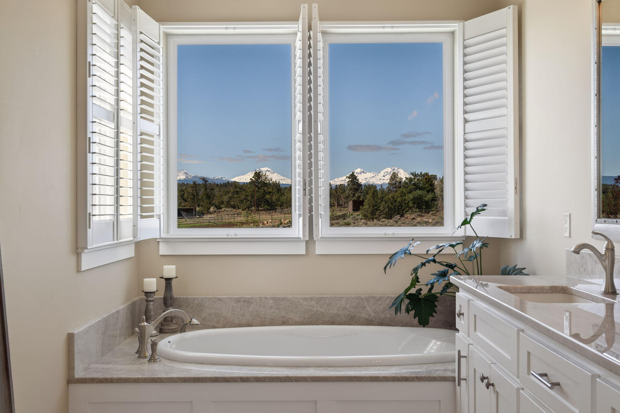 66355 Barr Road Bend, OR 97703 - Photo 24 of 56 a bathroom with a tub sink and mirror