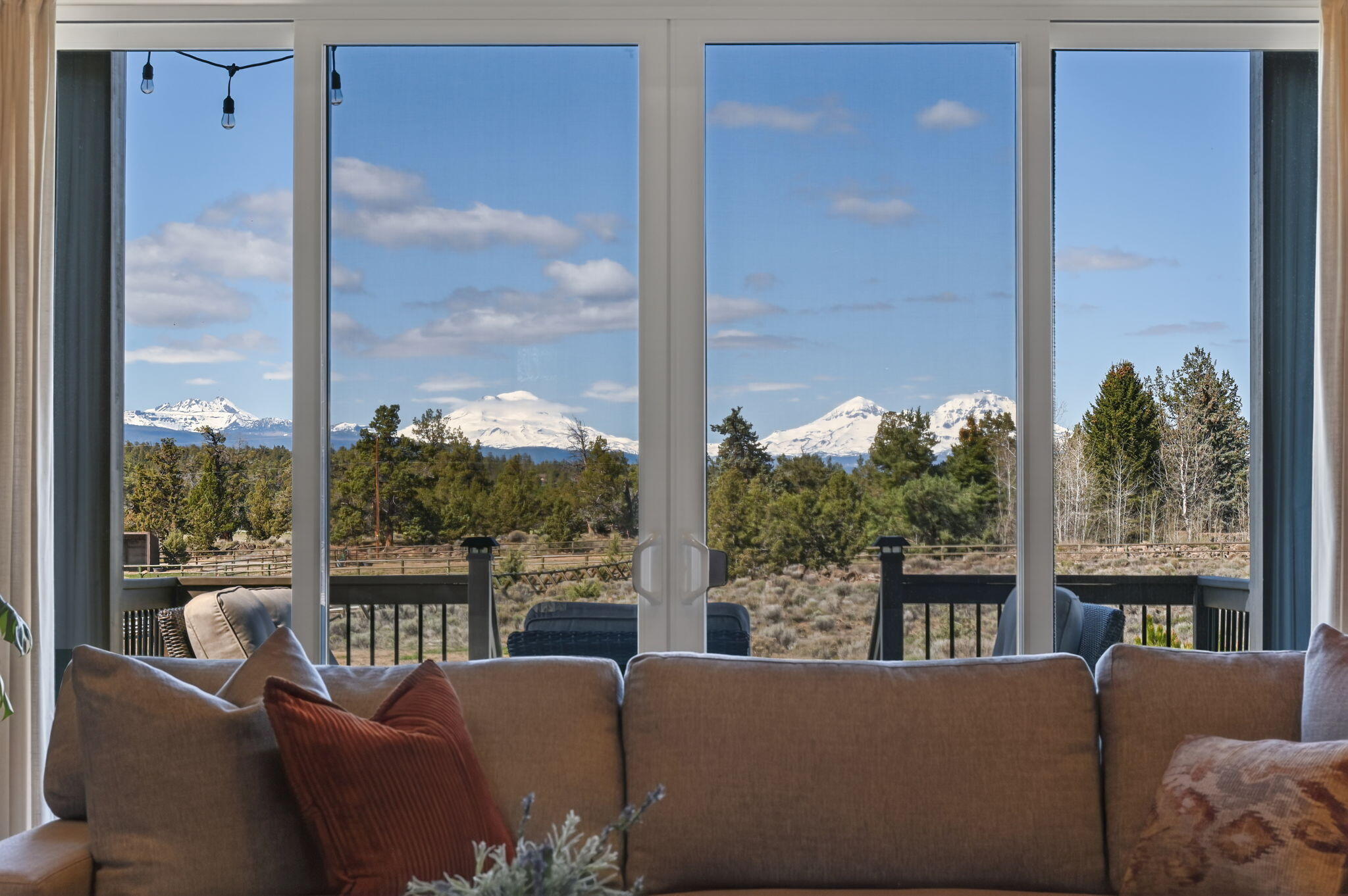 66355 Barr Road Bend, OR 97703 - Photo 45 of 56 a living room with furniture large windows and garden view
