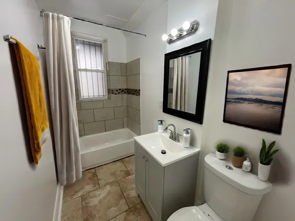 a bathroom with a sink toilet and shower