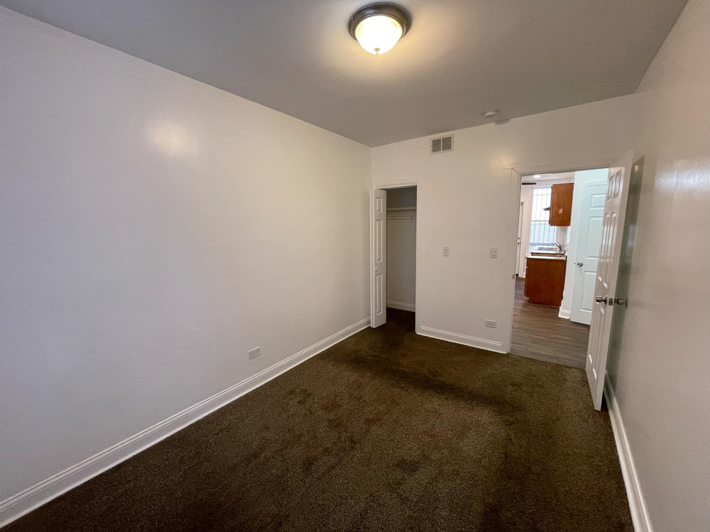 1635 West 57th Street, Unit 1 Chicago, IL 60636 - Photo 15 of 16 an empty room with wooden floor and windows