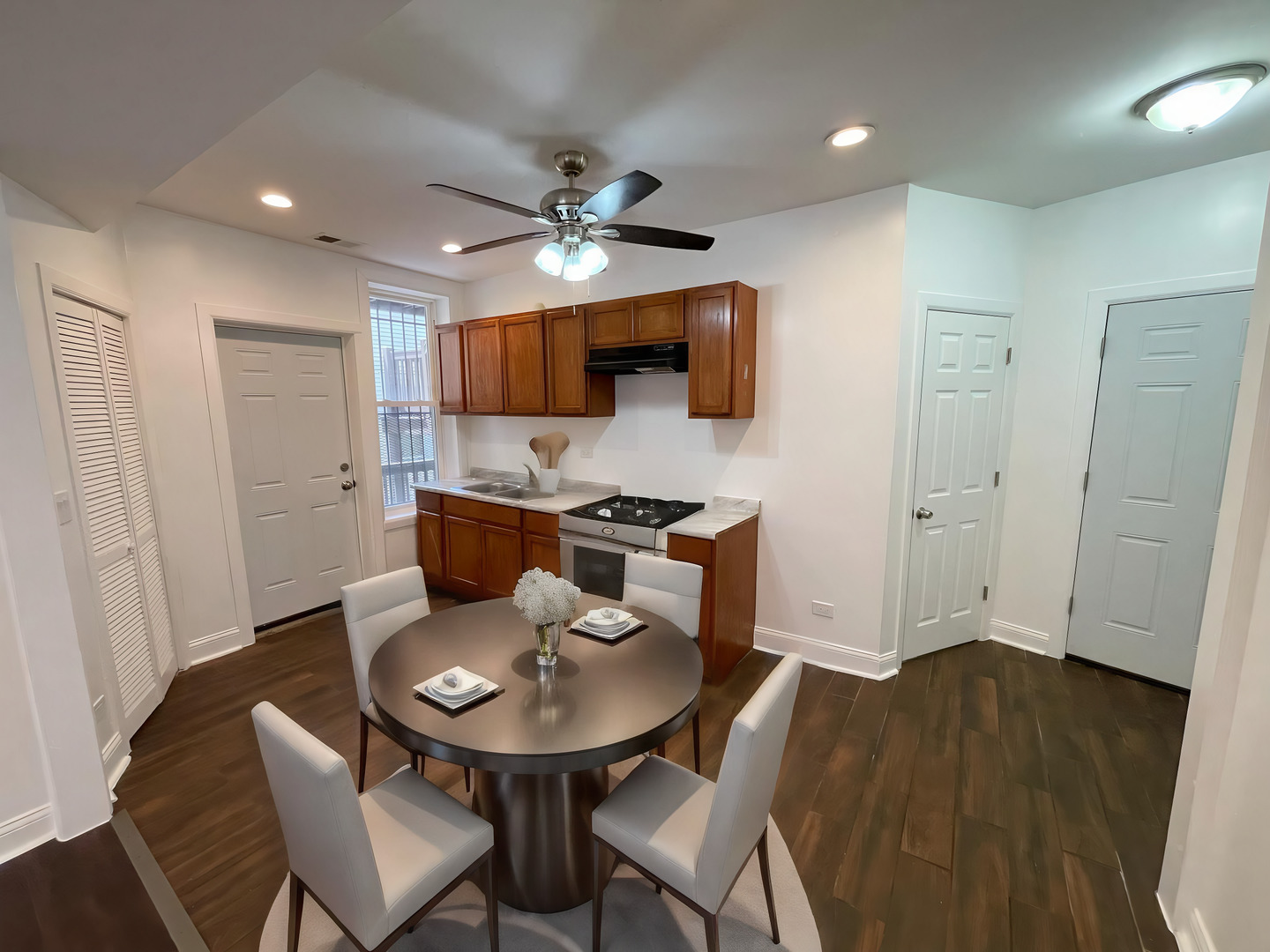 1635 West 57th Street, Unit 1 Chicago, IL 60636 - Photo 3 of 16 a kitchen with a table and chairs in it