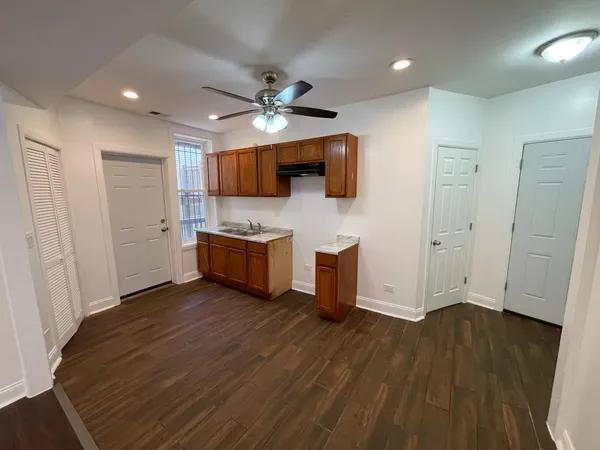 a view of a kitchen with a sink and a refrigerator
