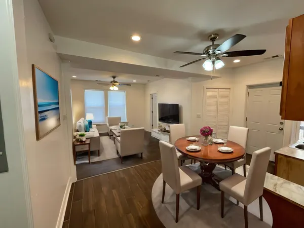 a view of a dining room with furniture and wooden floor