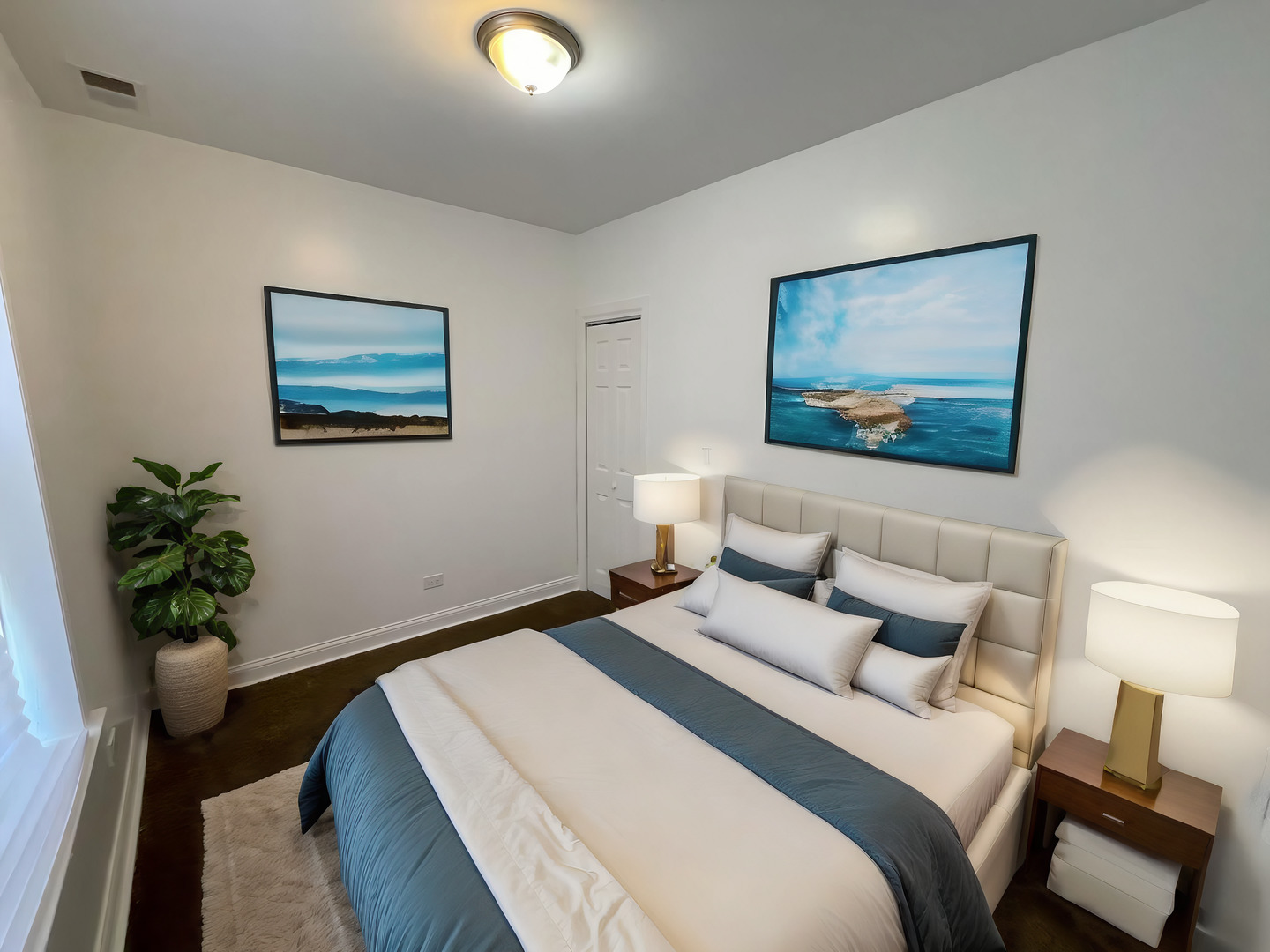 1635 West 57th Street, Unit 1 Chicago, IL 60636 - Photo 9 of 16 a bedroom with bed painting on the wall and a potted plant