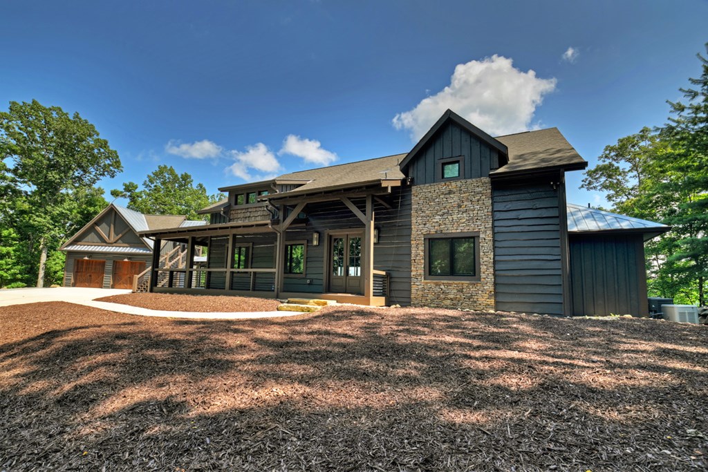 440 Cochise Road Cherry Log, GA 30522 - Photo 51 of 82 a front view of a house with a yard and garage