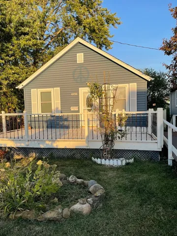 a front view of a house with a yard table and chairs