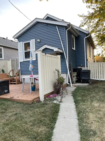 a backyard of a house that has a couch and a fireplace