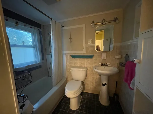 a bathroom with a sink toilet and mirror