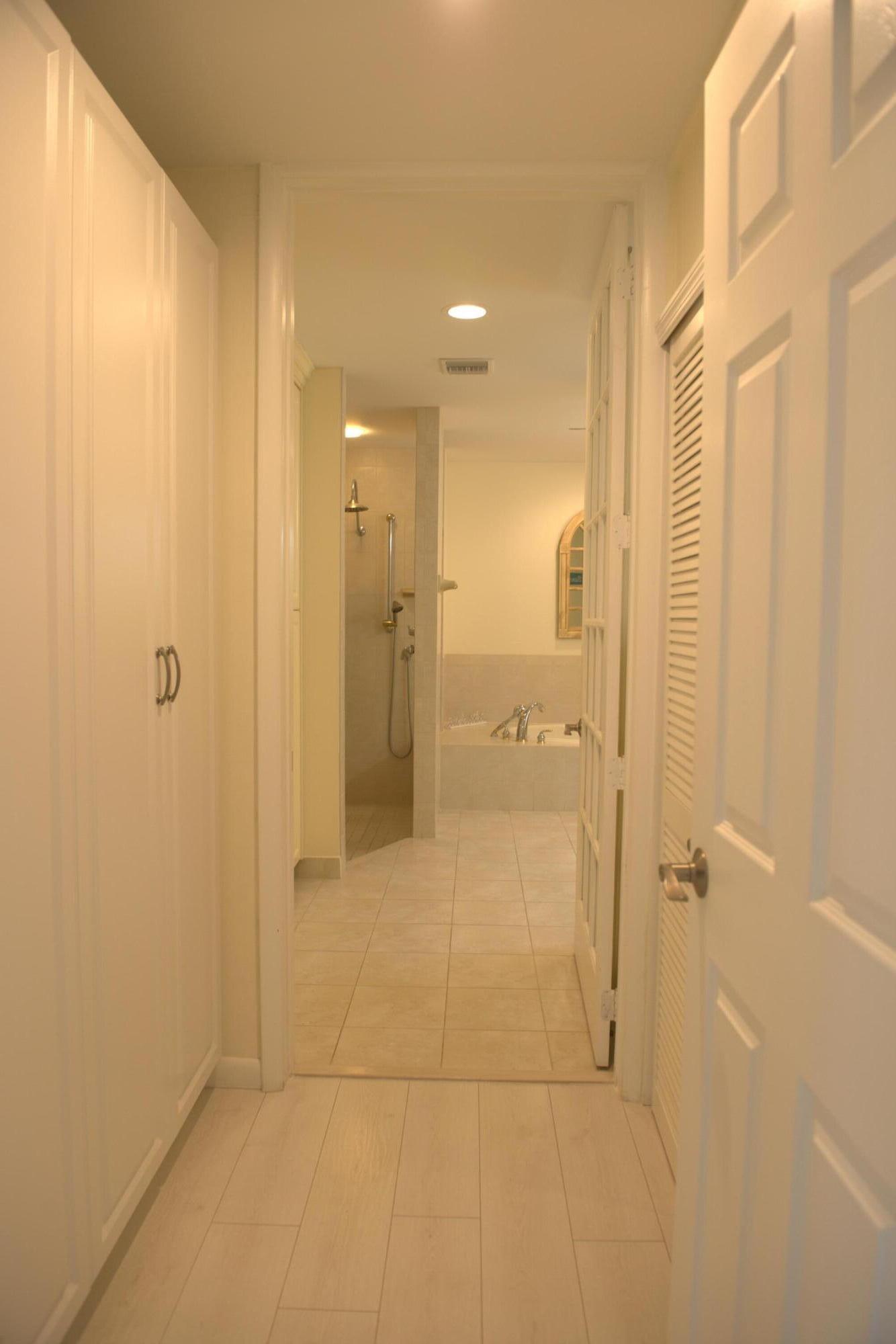 114 Beach Summit Court Jupiter, FL 33477 - Photo 19 of 32 a bathroom with a shower and a glass door