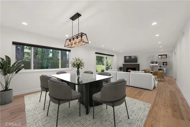 a dining room with furniture a chandelier and wooden floor