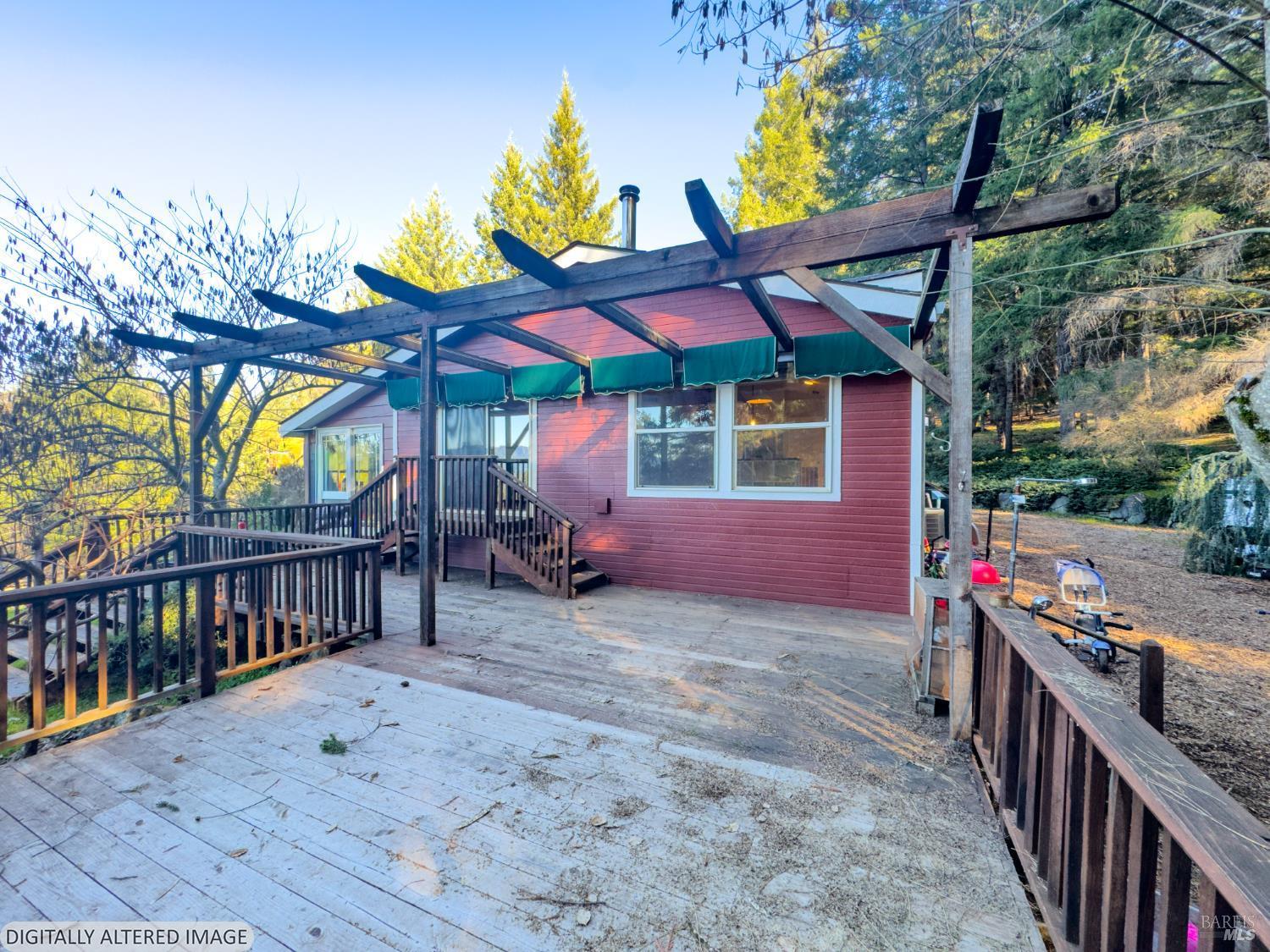 14475 Poonkinney Road Dos Rios, CA 95429 - Photo 19 of 25 a view of a patio with a table and chairs under an umbrella