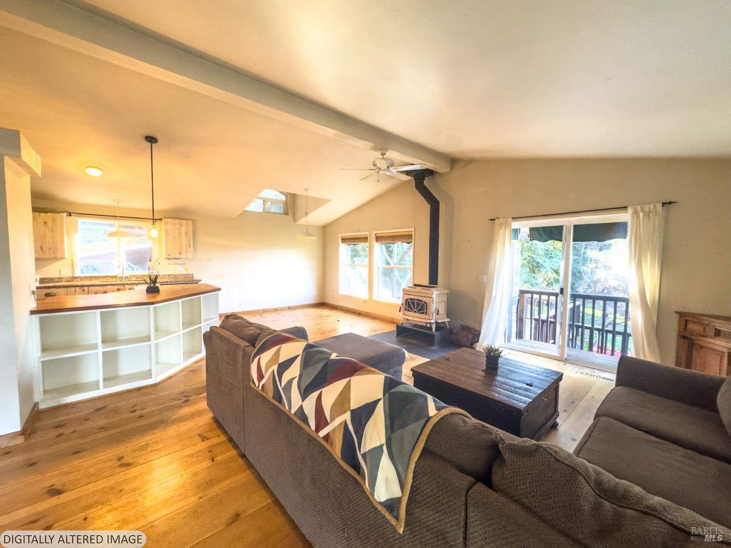 14475 Poonkinney Road Dos Rios, CA 95429 - Photo 3 of 25 a spacious bedroom with a bed a couch and dresser