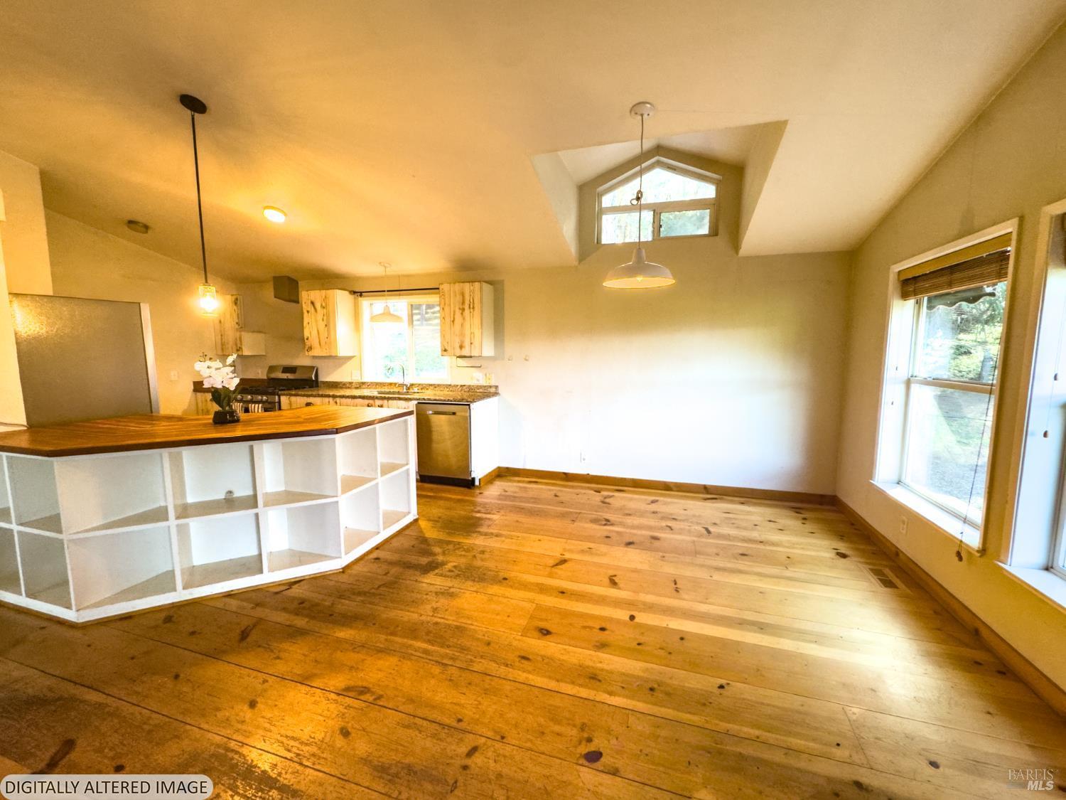14475 Poonkinney Road Dos Rios, CA 95429 - Photo 7 of 25 a view of a kitchen with kitchen island a stove a sink and a wooden floors