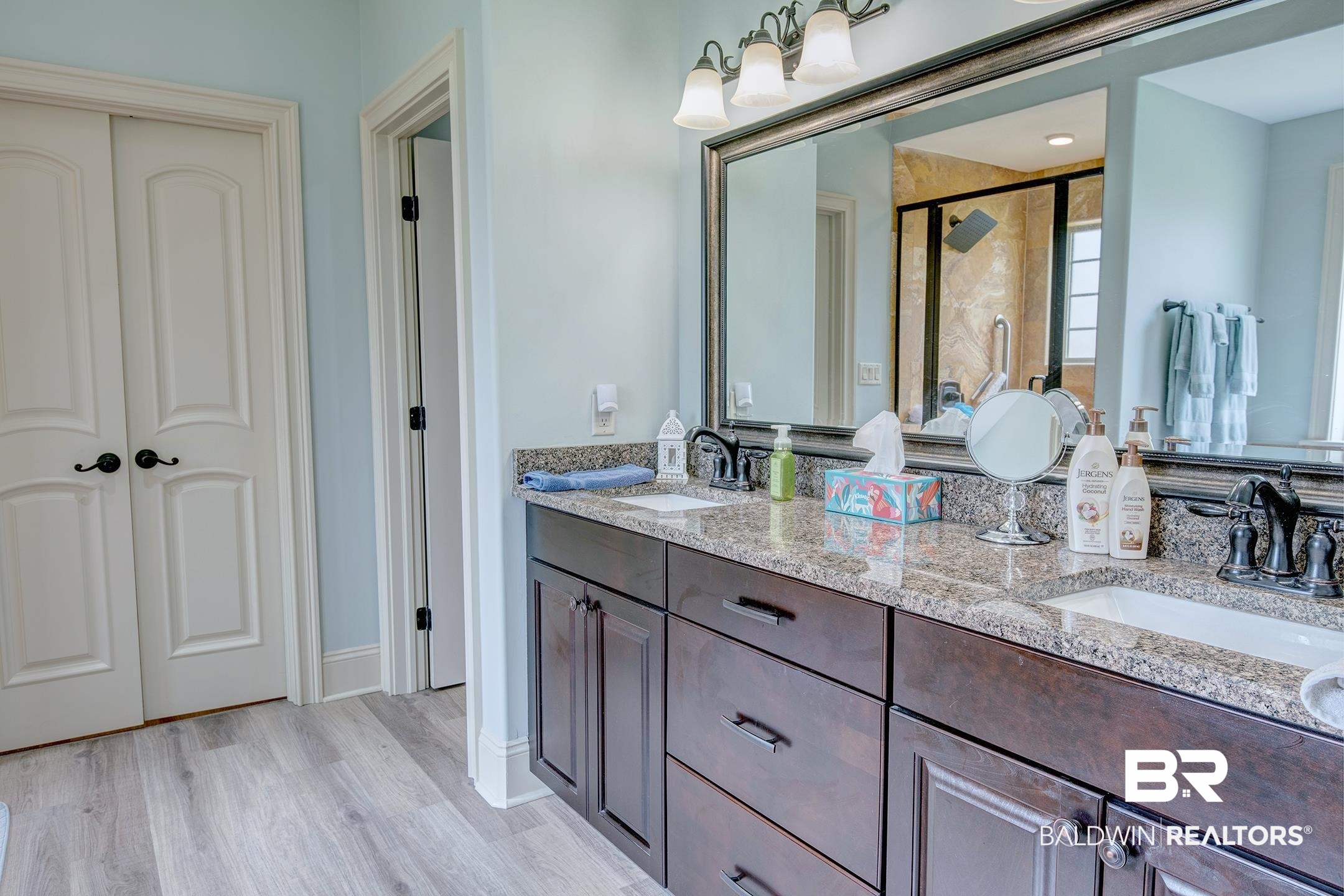 9357 Lakeview Drive Foley, AL 36535 - Photo 37 of 68 Dual vanity with granite countertop, dark wood-finish cabinetry, and undermount sinks