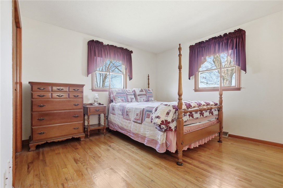 6718 Old Columbus Road South Vienna, OH 45369 - Photo 16 of 33 This serene bedroom features warm hardwood floors and natural light from charming windows.
