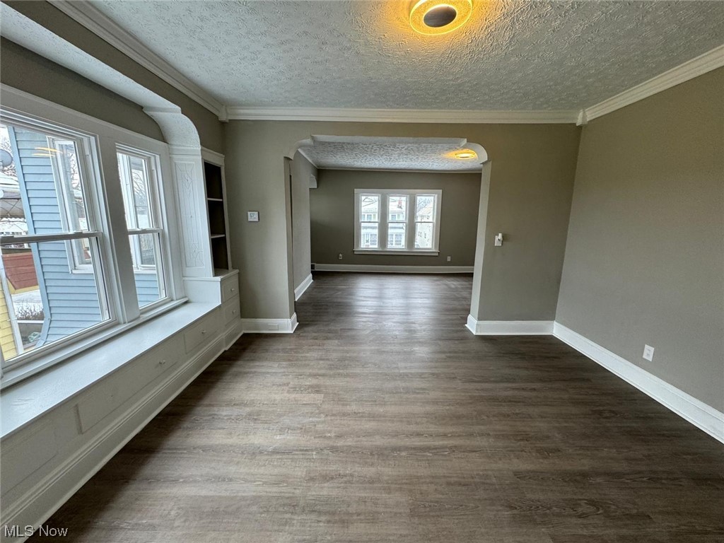 3333 Berea Road Cleveland, OH 44111 - Photo 25 of 34 Unfurnished room featuring dark hardwood / wood-style flooring, ornamental molding, and a textured ceiling