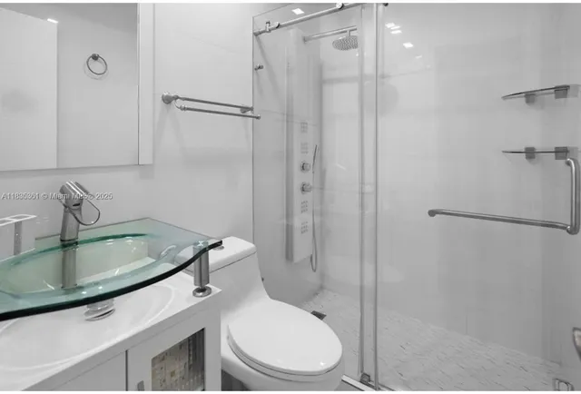 a bathroom with a sink toilet and shower