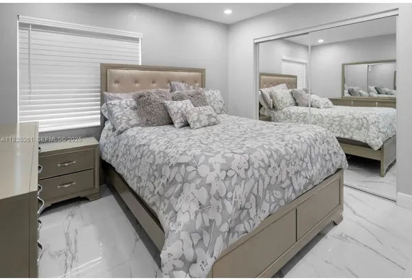 a bedroom with a bed and two dressers