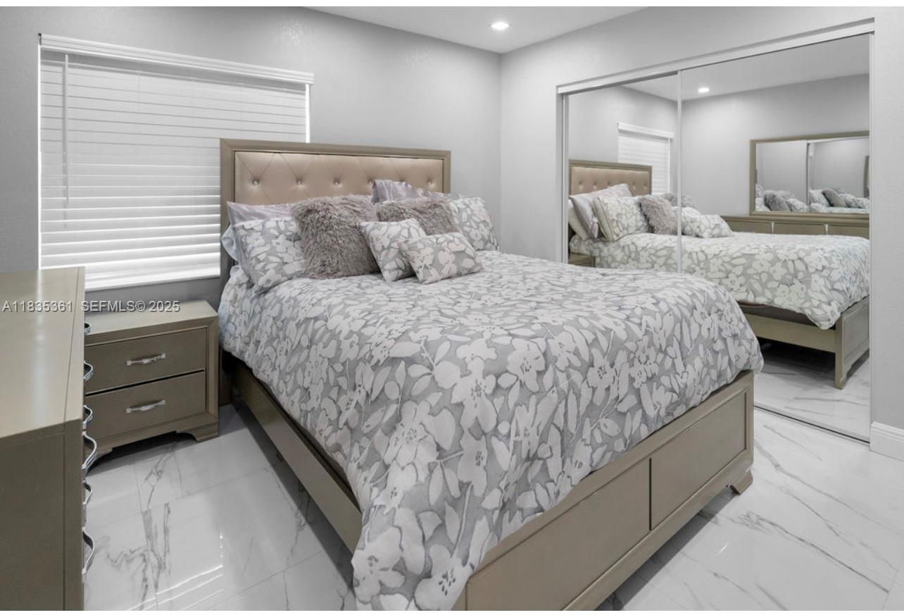 1158 West 41st Street, Unit 87 Hialeah, FL 33012 - Photo 14 of 16 a bedroom with a bed and two dressers