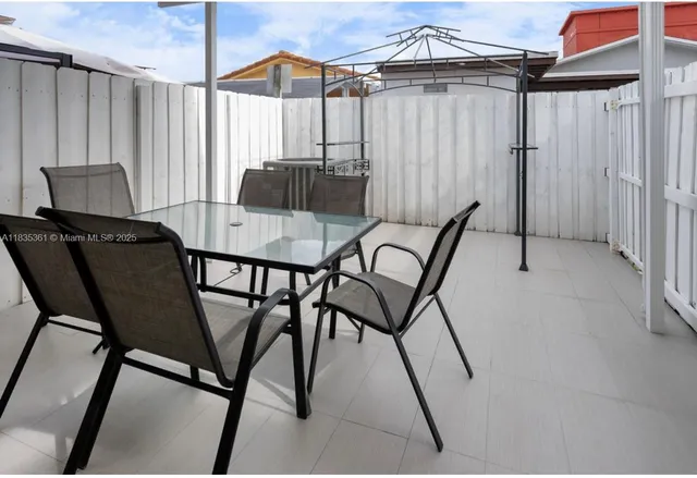 a dining room with furniture and a window
