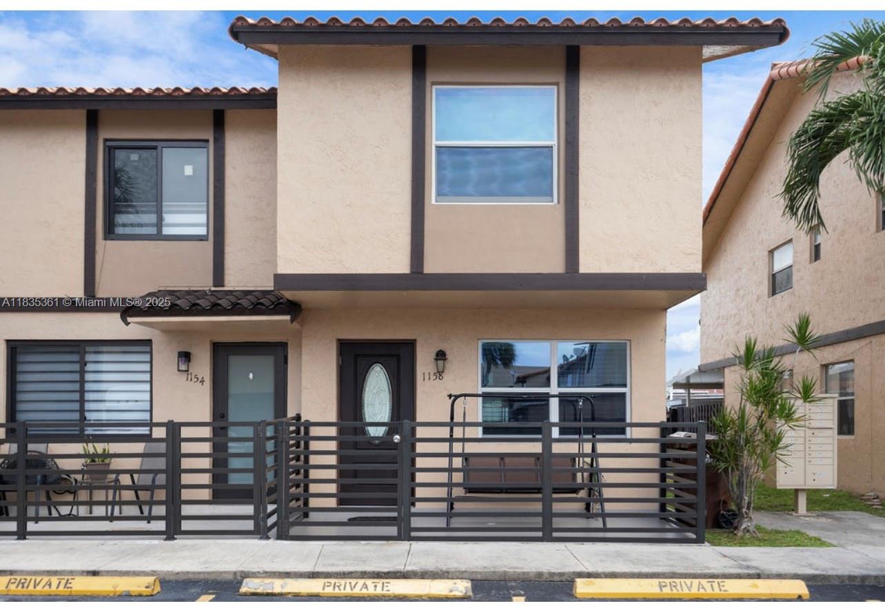 1158 West 41st Street, Unit 87 Hialeah, FL 33012 - Photo 2 of 16 a front view of a house with garage