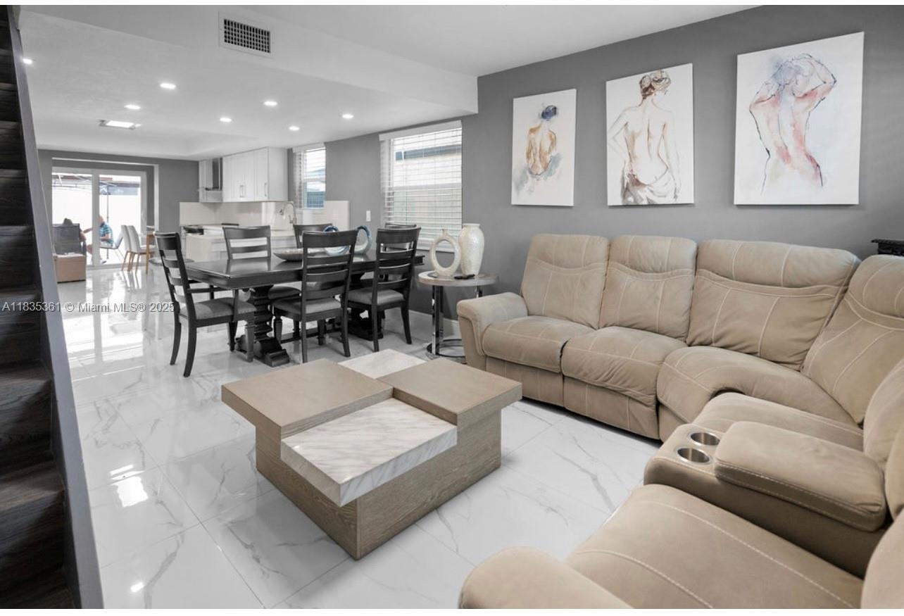 1158 West 41st Street, Unit 87 Hialeah, FL 33012 - Photo 4 of 16 a living room with furniture wooden floor and kitchen view