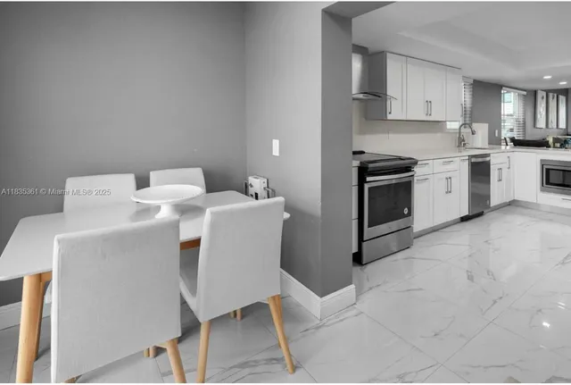 a kitchen with a sink cabinets and stainless steel appliances