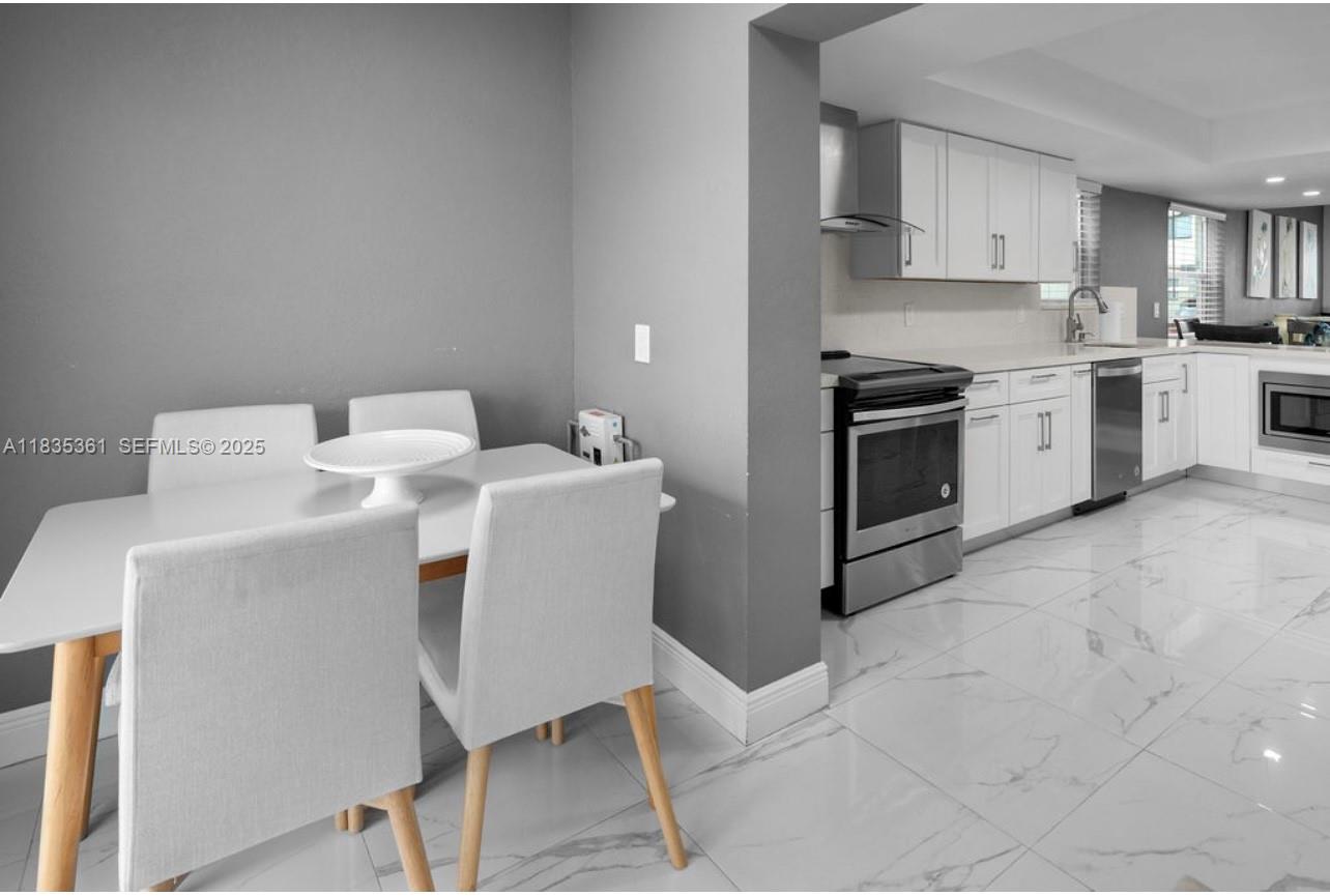 1158 West 41st Street, Unit 87 Hialeah, FL 33012 - Photo 7 of 16 a kitchen with a sink cabinets and appliances