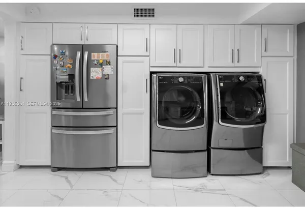 a kitchen with stainless steel appliances granite countertop a refrigerator and a stove