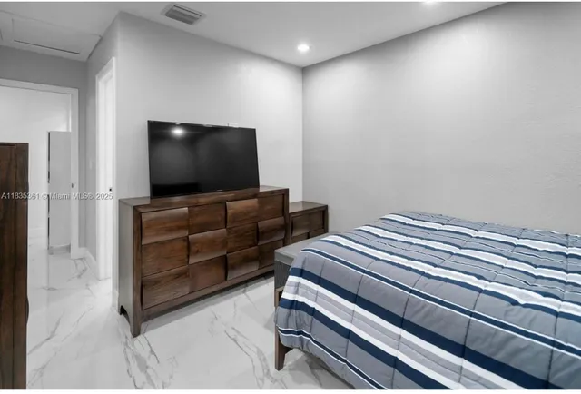 a room with furniture and flat screen tv