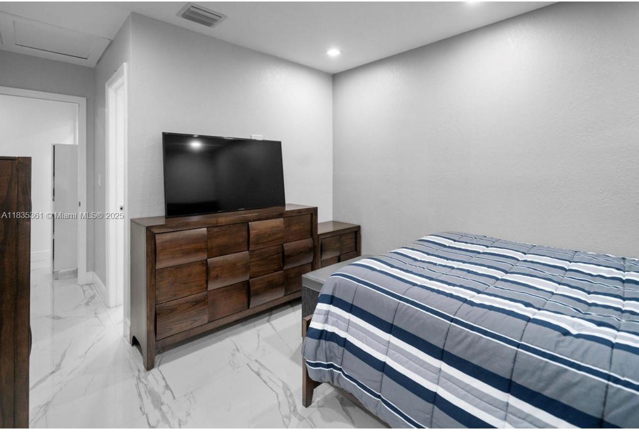 1158 West 41st Street, Unit 87 Hialeah, FL 33012 - Photo 10 of 16 a room with furniture and flat screen tv
