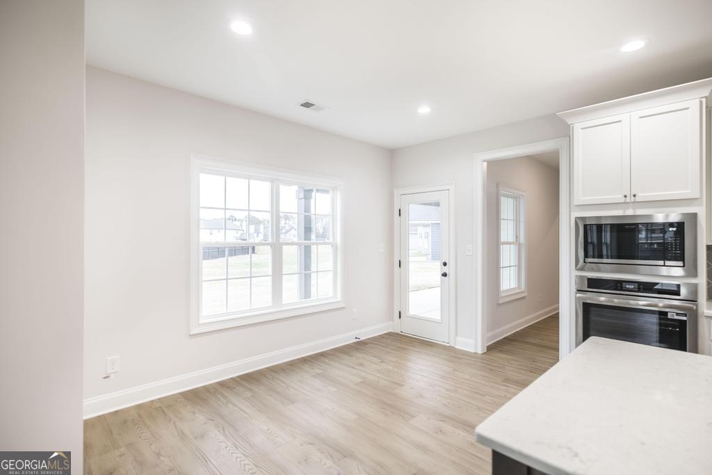 409 Bella Notte Circle, Unit 1D Warner Robins, GA 31088 - Photo 11 of 34 a view of a kitchen with wooden floor and a sink