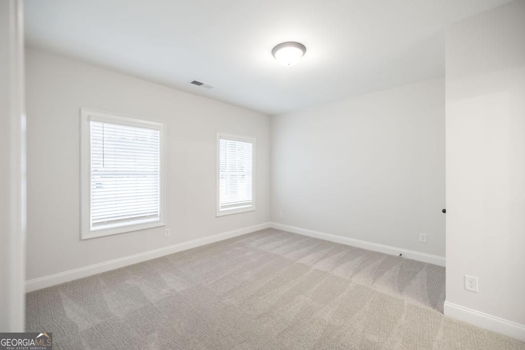 409 Bella Notte Circle, Unit 1D Warner Robins, GA 31088 - Photo 15 of 34 an empty room with windows