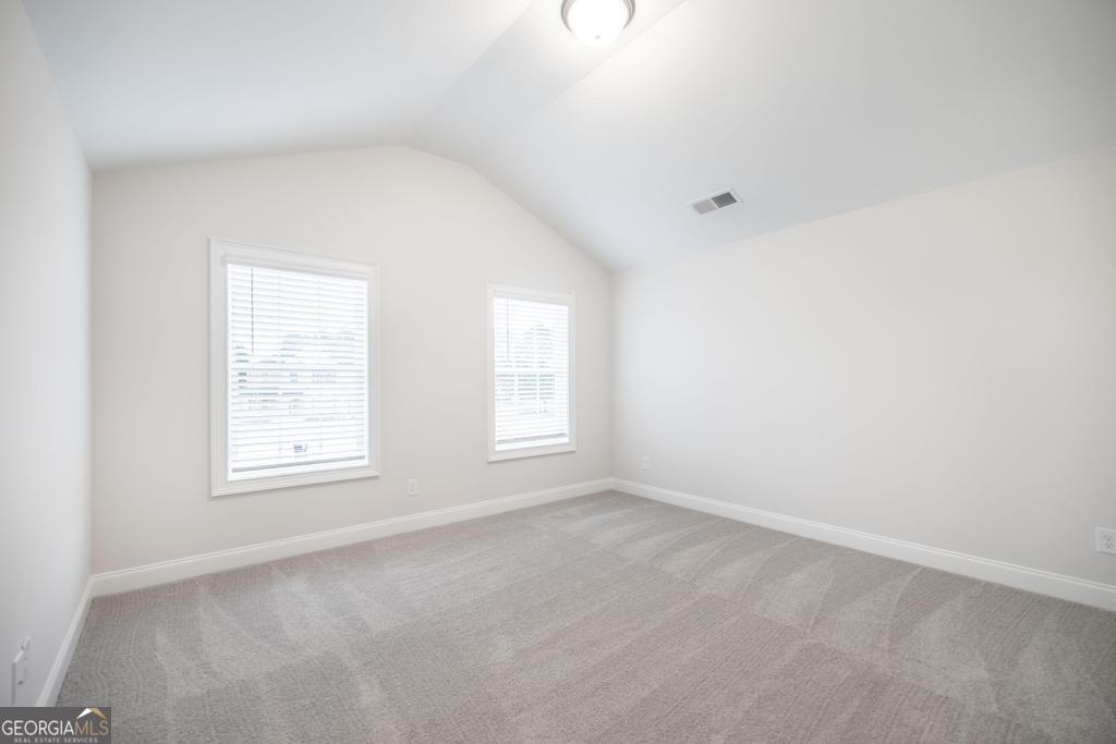 409 Bella Notte Circle, Unit 1D Warner Robins, GA 31088 - Photo 19 of 34 an empty room with windows