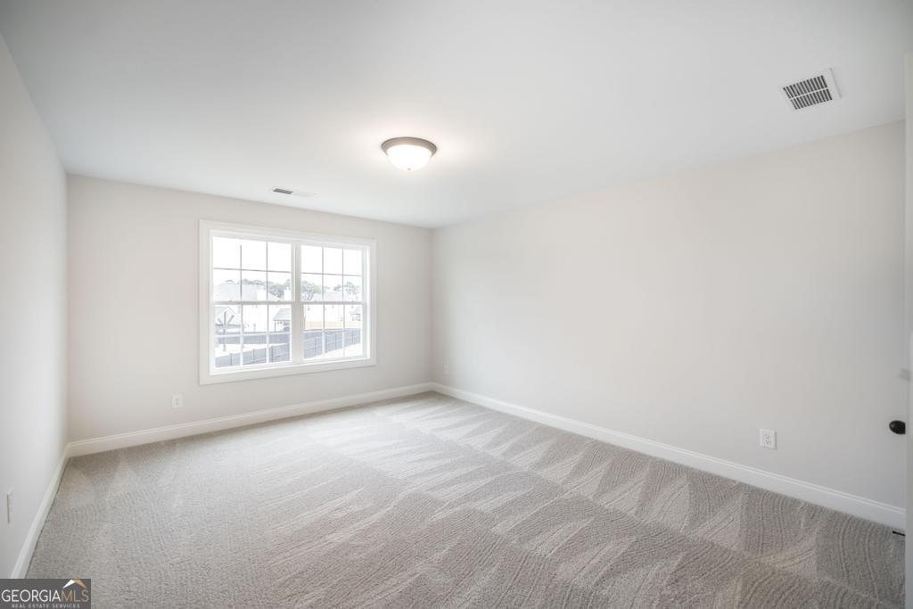 409 Bella Notte Circle, Unit 1D Warner Robins, GA 31088 - Photo 26 of 34 an empty room with a window