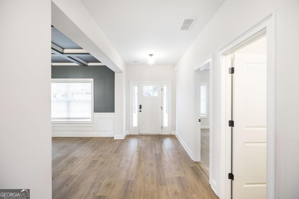 409 Bella Notte Circle, Unit 1D Warner Robins, GA 31088 - Photo 3 of 34 a view of hallway with wooden floor