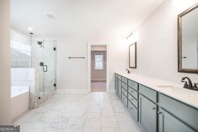 a bathroom with a bathtub and shower