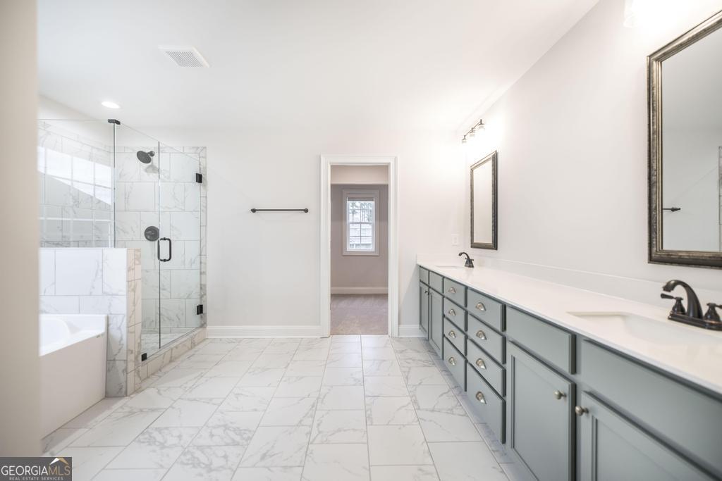 409 Bella Notte Circle, Unit 1D Warner Robins, GA 31088 - Photo 31 of 34 a bathroom with a double vanity sink and a mirror