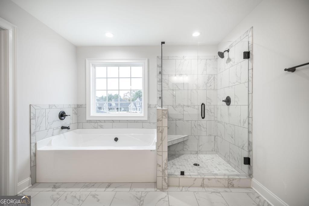 409 Bella Notte Circle, Unit 1D Warner Robins, GA 31088 - Photo 32 of 34 a bathroom with a bathtub and shower
