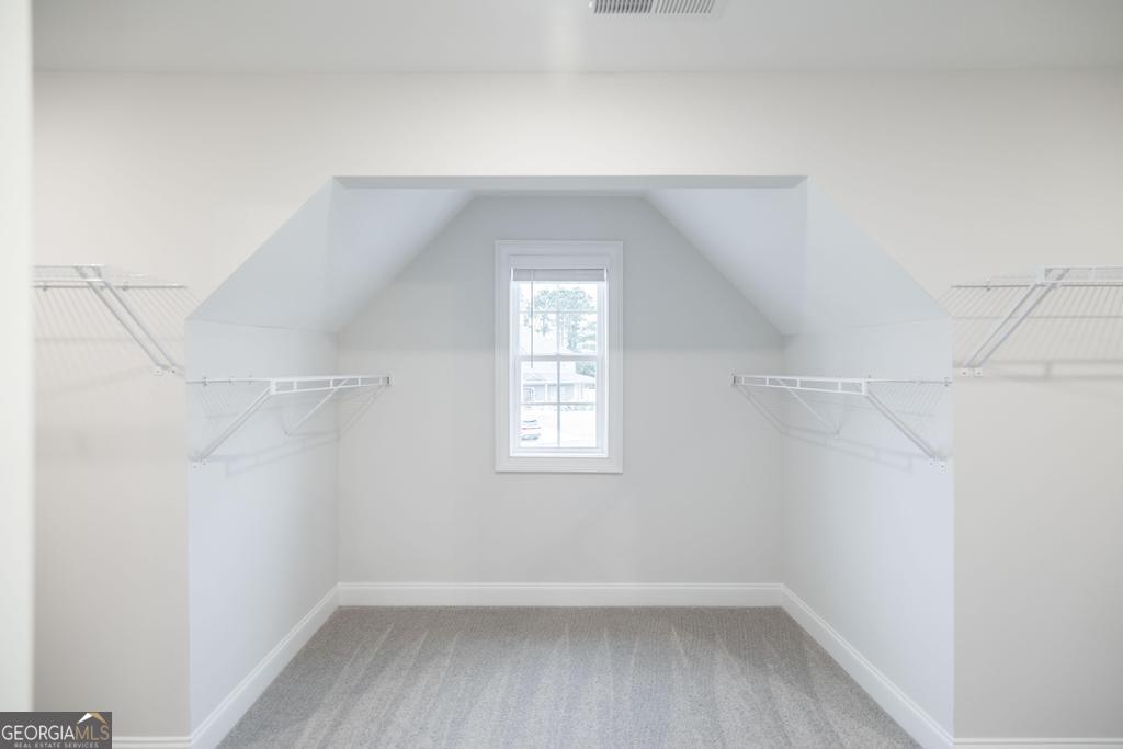 409 Bella Notte Circle, Unit 1D Warner Robins, GA 31088 - Photo 33 of 34 a view of a small space with wooden floor and windows in a room