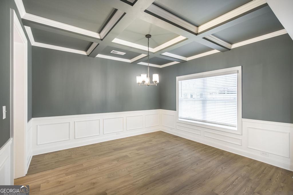 409 Bella Notte Circle, Unit 1D Warner Robins, GA 31088 - Photo 4 of 34 an empty room with wooden floor and windows