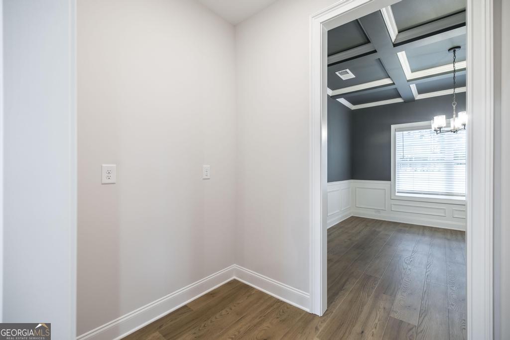 409 Bella Notte Circle, Unit 1D Warner Robins, GA 31088 - Photo 5 of 34 a view of an empty room with wooden floor and a window