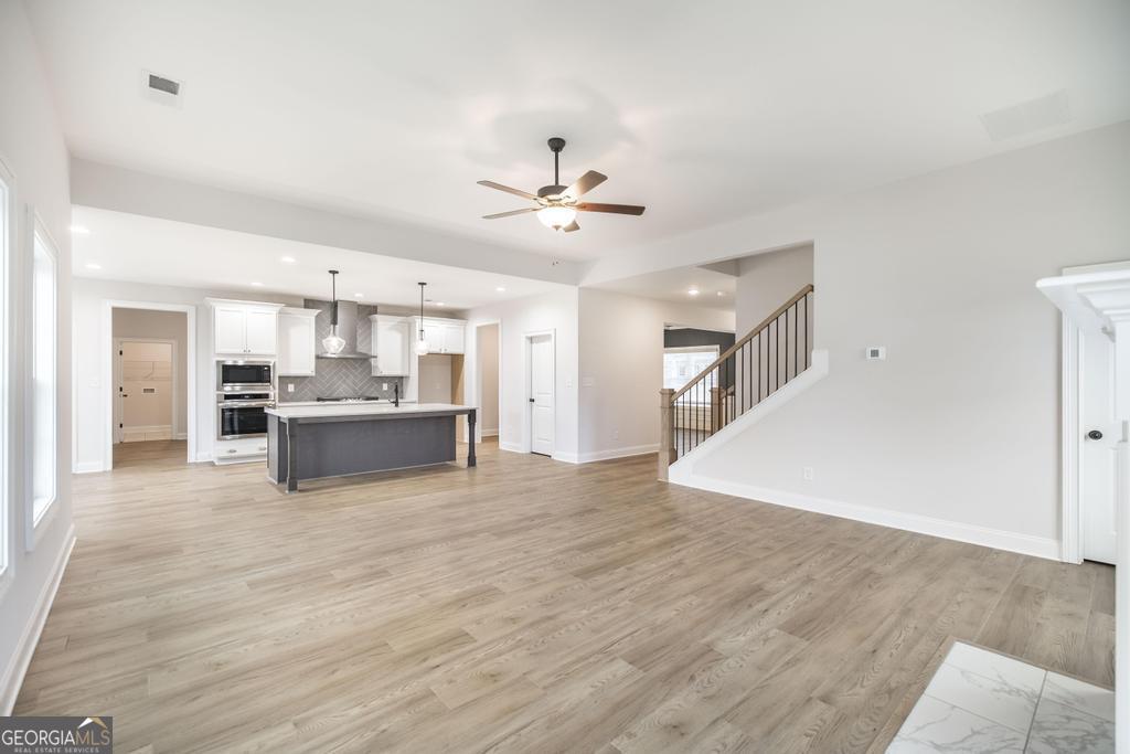 409 Bella Notte Circle, Unit 1D Warner Robins, GA 31088 - Photo 7 of 34 a view of kitchen with cabinets and wooden floor