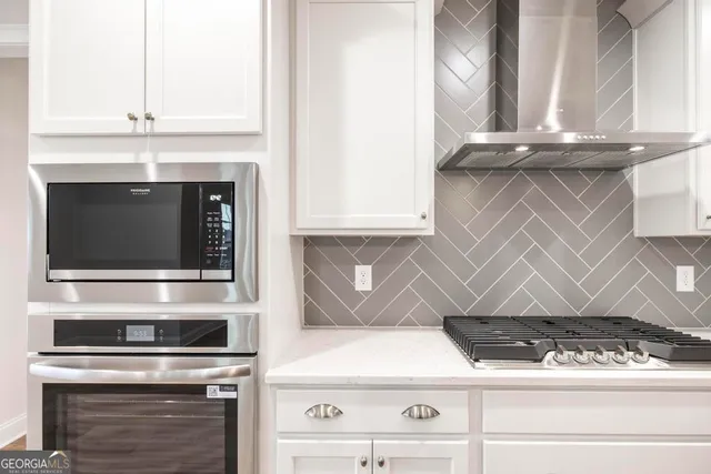 a view of a kitchen with wooden floor and a sink