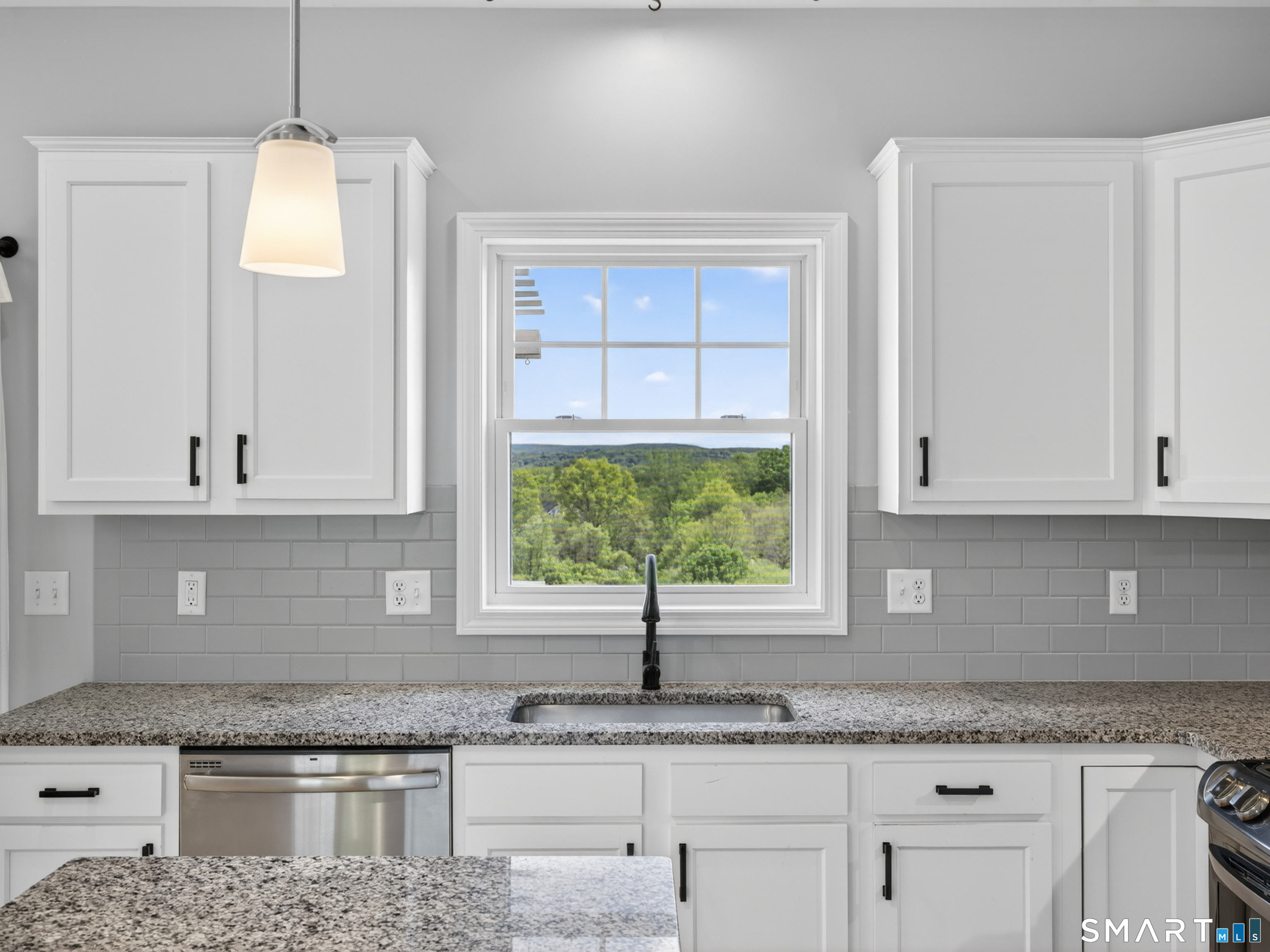 650 Ridgewood Road Middletown, CT 06457 - Photo 12 of 40 a kitchen with granite countertop a sink window and cabinets