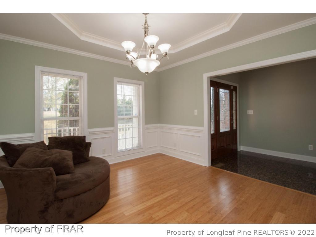 510 Booth Pond Road Raeford, NC 28376 - Photo 19 of 36 a living room with furniture and a chandelier
