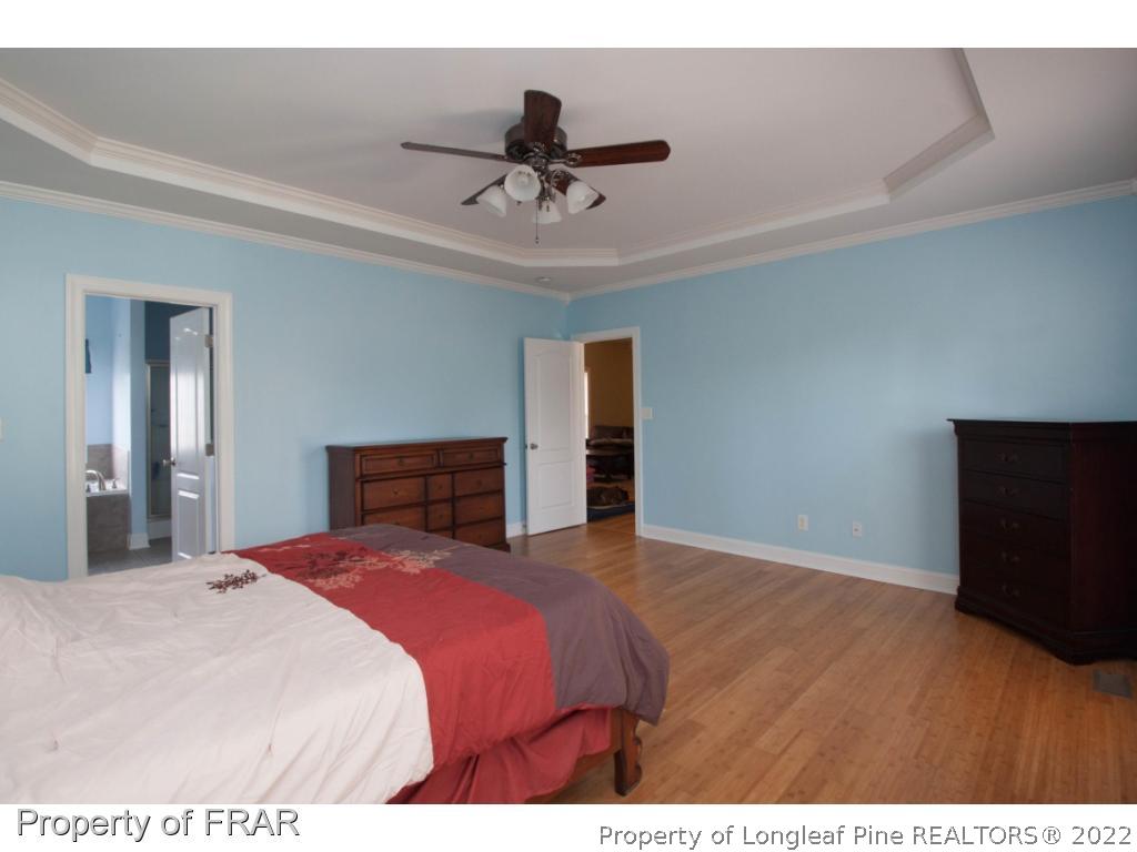 510 Booth Pond Road Raeford, NC 28376 - Photo 22 of 36 a bedroom with a bed and a night stand